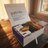 Gift box with wooden items and an italian handmade spagetti bowl, featuring the brand 'patrida' gift box.