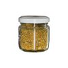 Glass jar with white lid containing wild fennel pollen from italy on a white background