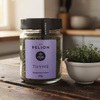 Jar of M.T. Pelion Thyme on a wooden surface with a blurred kitchen background