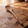 Wooden spoon on a wooden surface with natural light