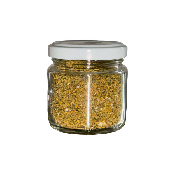 Glass jar with white lid containing wild fennel pollen from italy on a white background