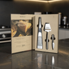 Set of Parmigiano Reggiano cheese tools in a box on a kitchen counter.